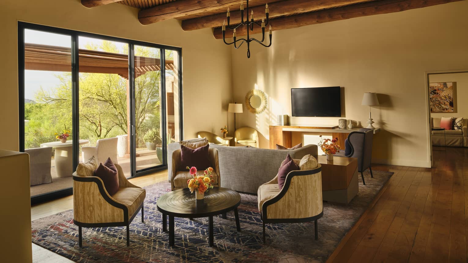 Luxury suite living room with contemporary Southwestern design and wooden, beamed ceiling