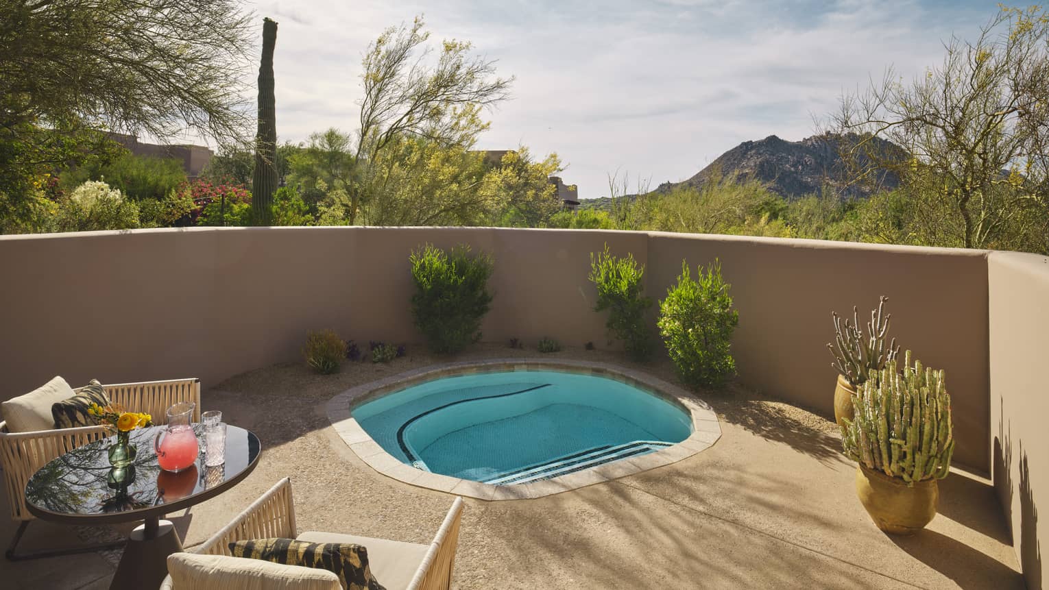Private plunge pool in a wall-enclosed terrace, surrounded by desert landscape