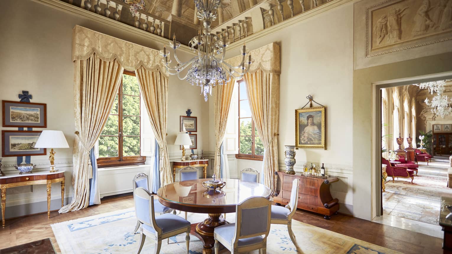 Royal Suite dining room with round table six upholstered chairs, frescoed ceiling with chandelier, at Four Seasons Hotel Florence