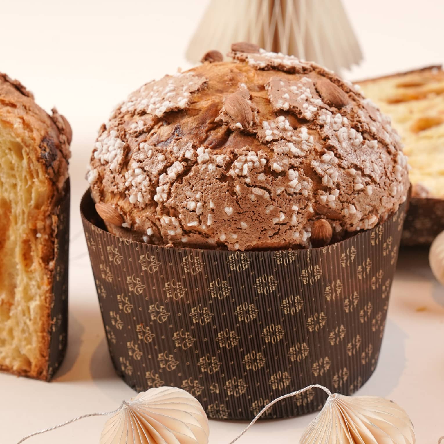 Panetonne on a white background with white paper Christmas decorations