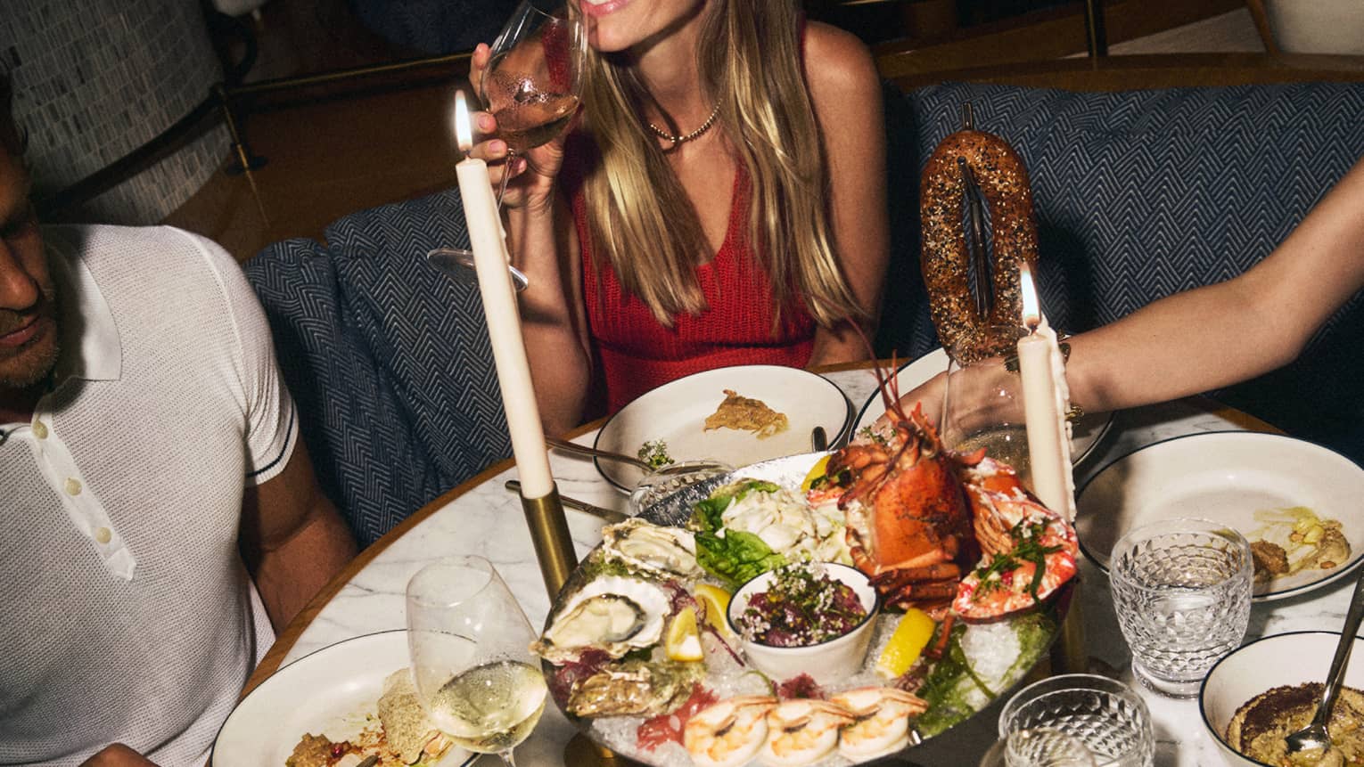 Oval table filled with large dinner spread including a seafood tray and more