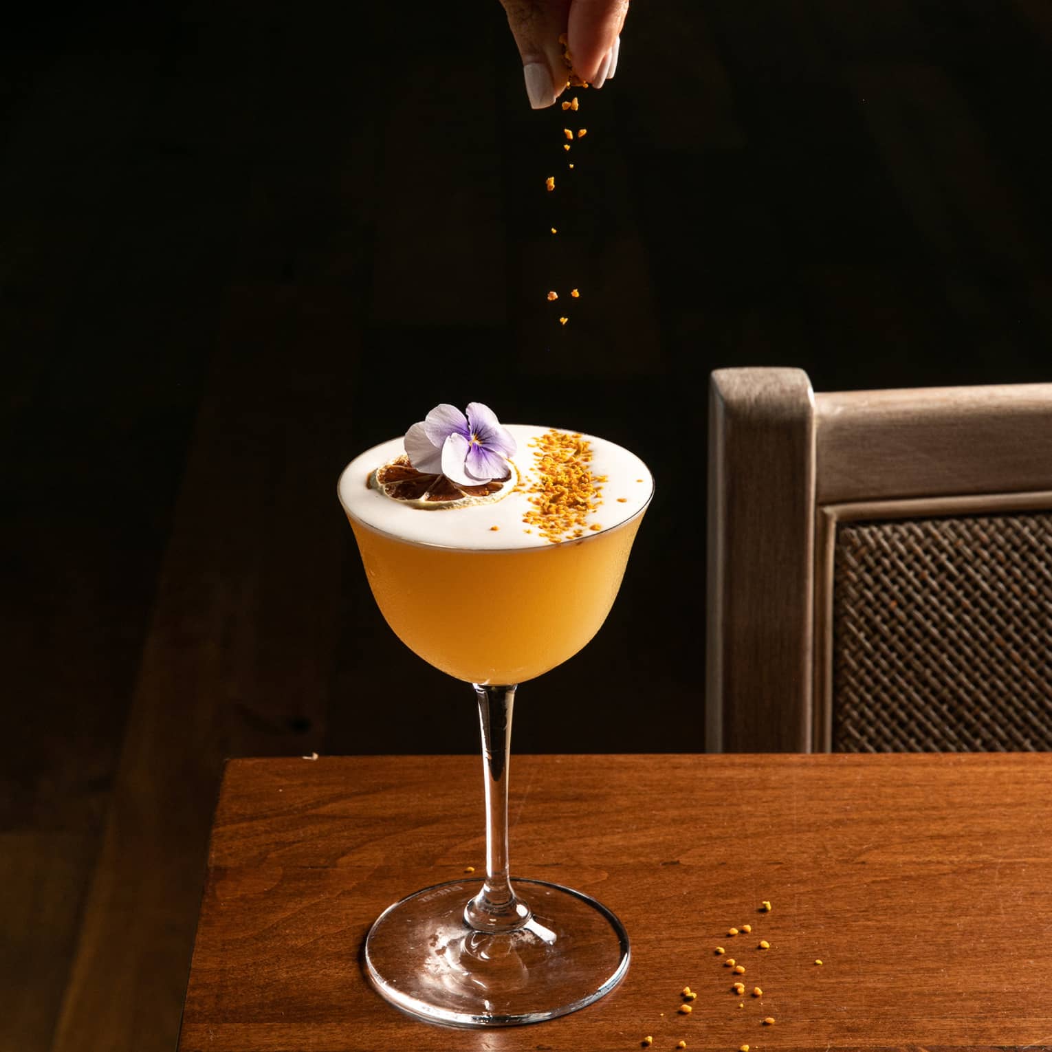 A cocktail being garnished.