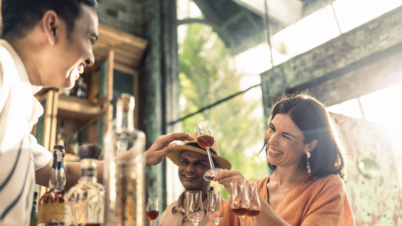 Smiling woman enjoys rum tasting at Rum Vault