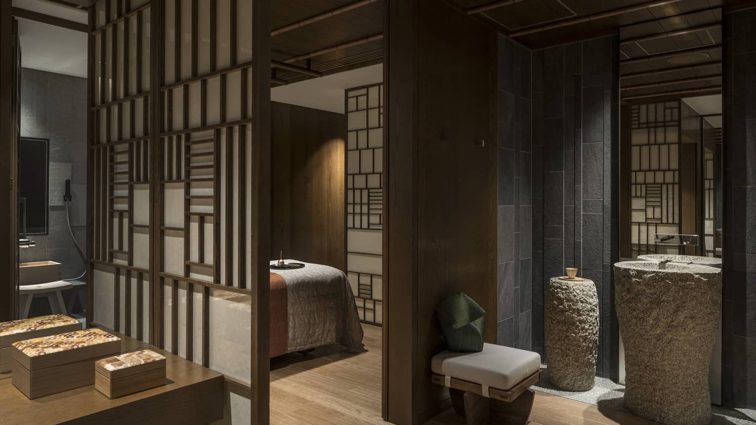Spa treatment rooms behind screens, large stone vases