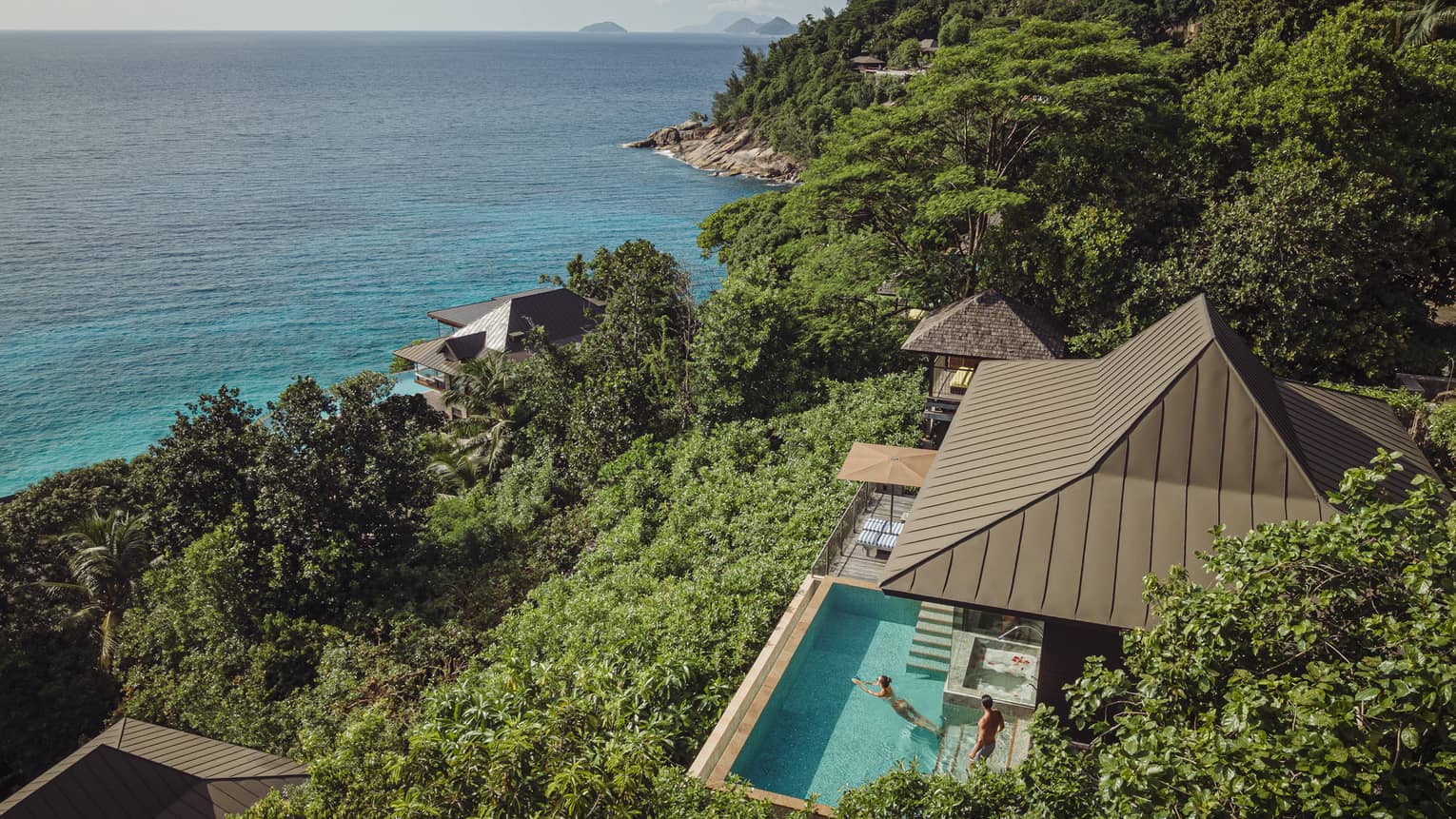 Aerial view of a Residence Villa at Four Seasons Resort Seychelles, overlooking turquoise ocean.