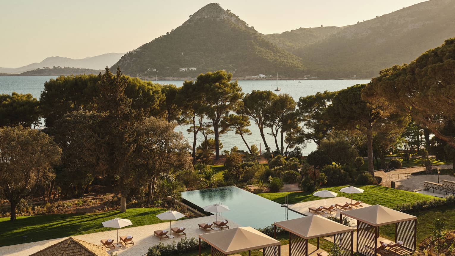 View of pool and ocean/mountain in background
