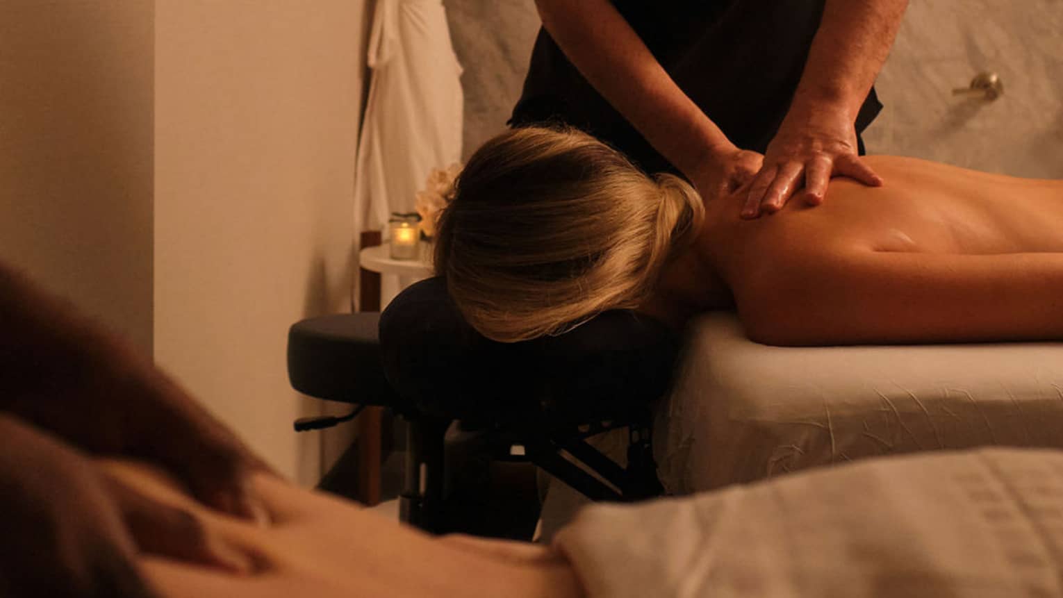 Couple getting side-by-side massages