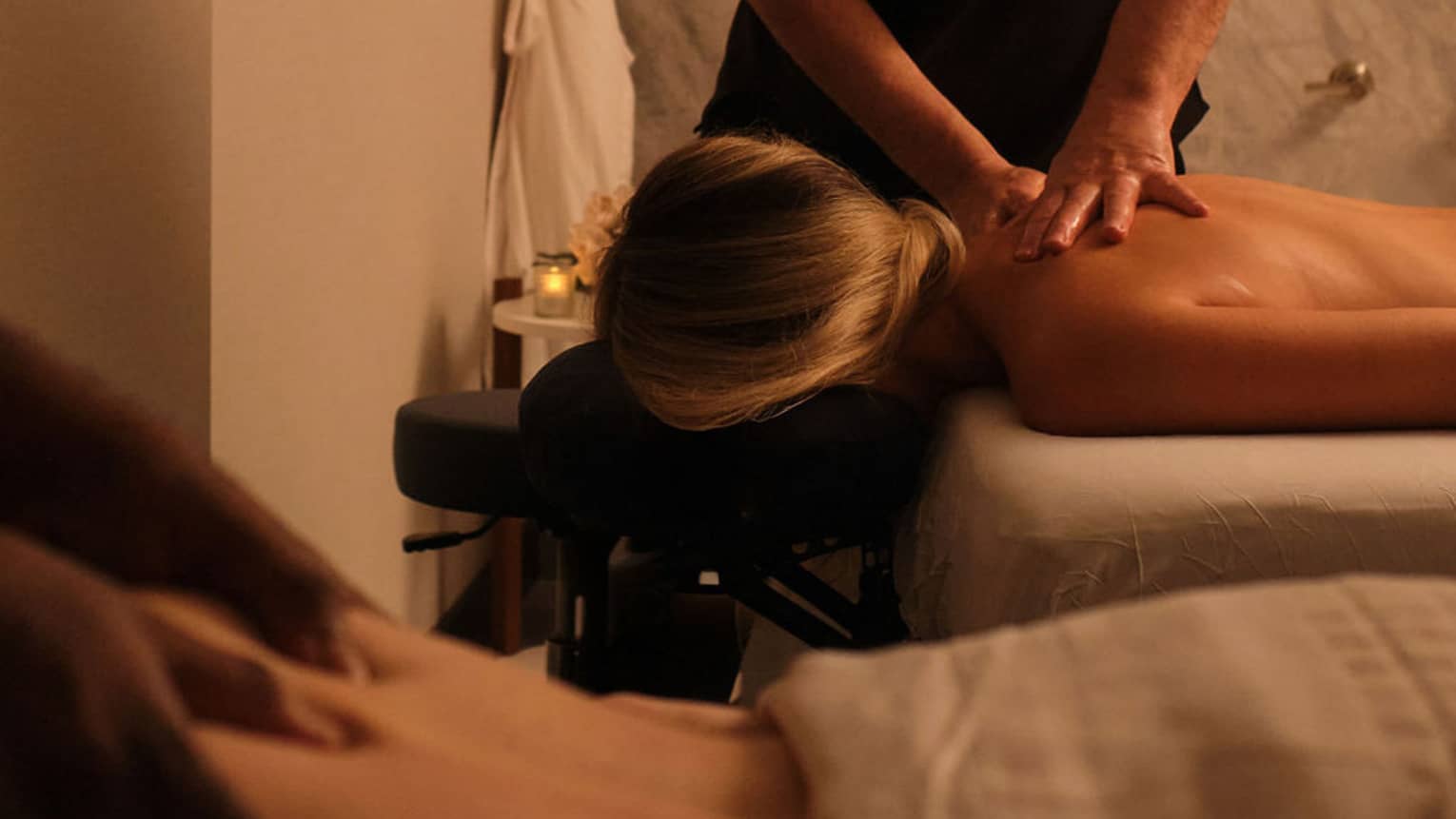 Couple getting side-by-side massages