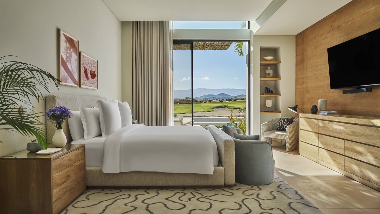 Bedroom with king bed, large dresser, TV, and walk-out terrace in private luxury villa at Four Seasons Resort and Residences Los Cabos