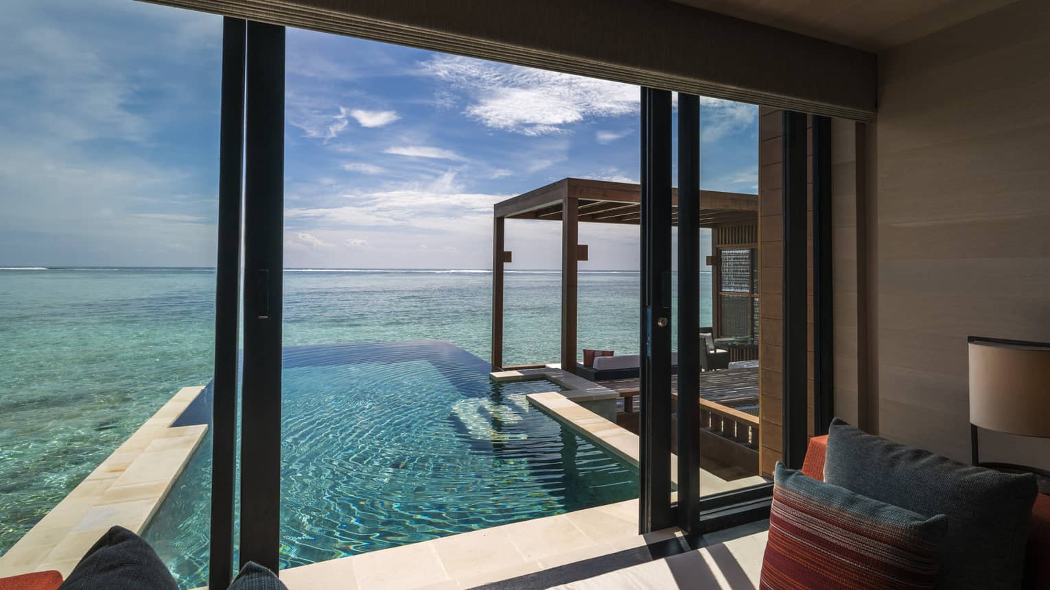 A view from inside the sunrise water villa with pool