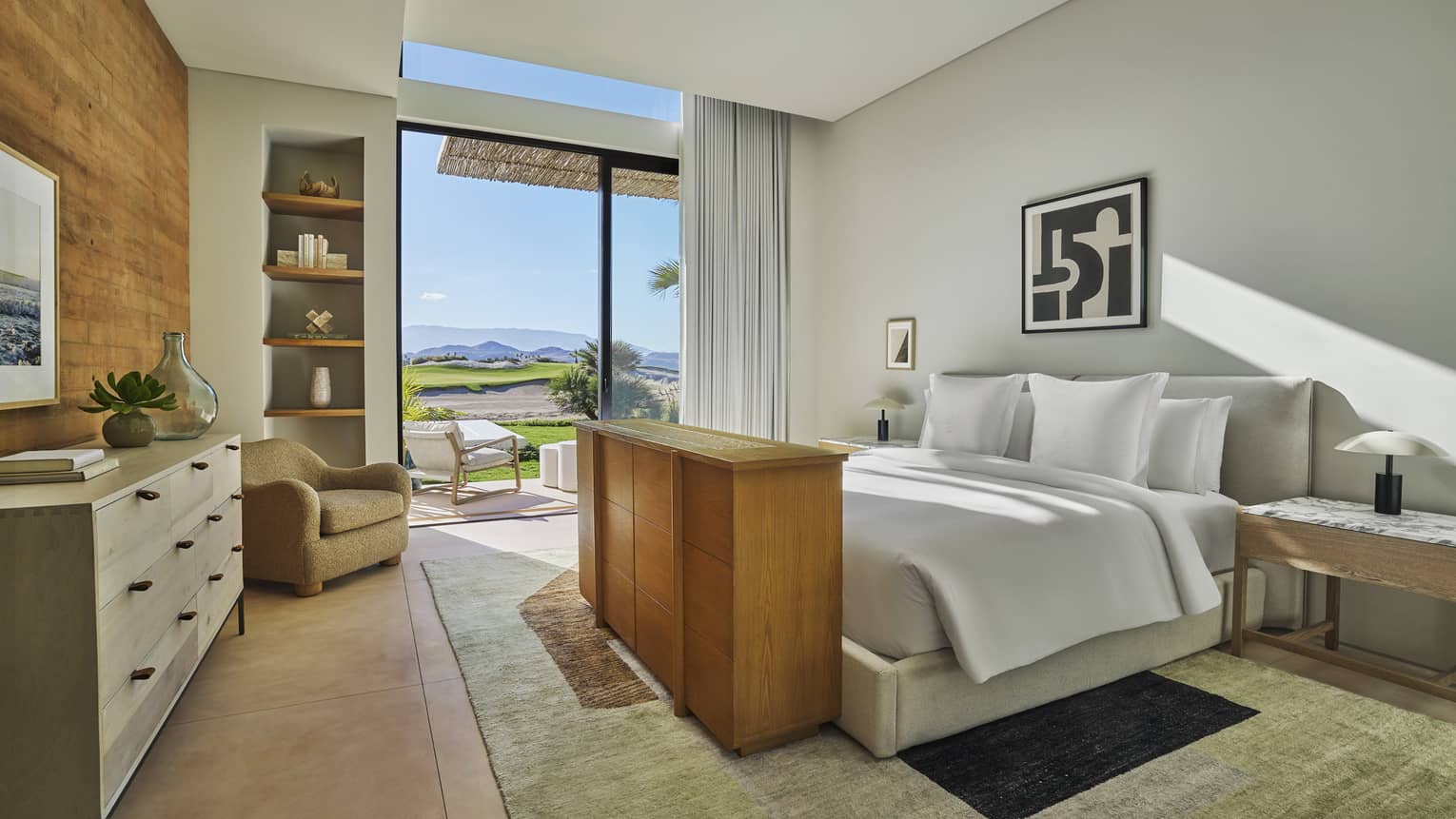 Large, light-filled bedroom with king bed and walk-out terrace with golf course view at Four Seasons Resort and Residences Los Cabos