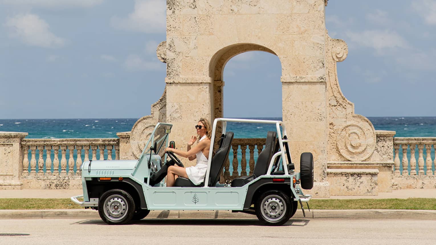 Catamaran sailing on the open water against mountain backdrop