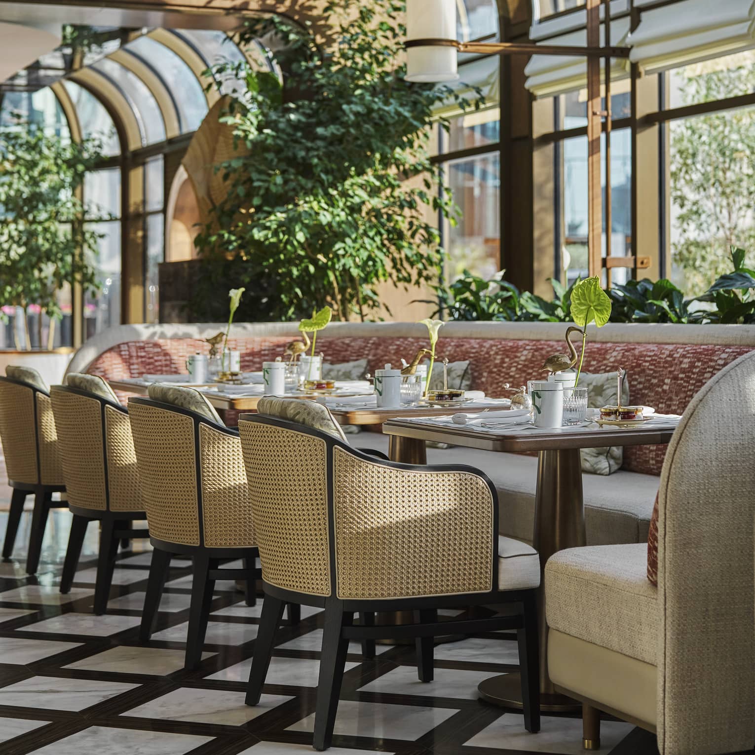 Restaurant dining room with a conservatory-style wall of curved windows