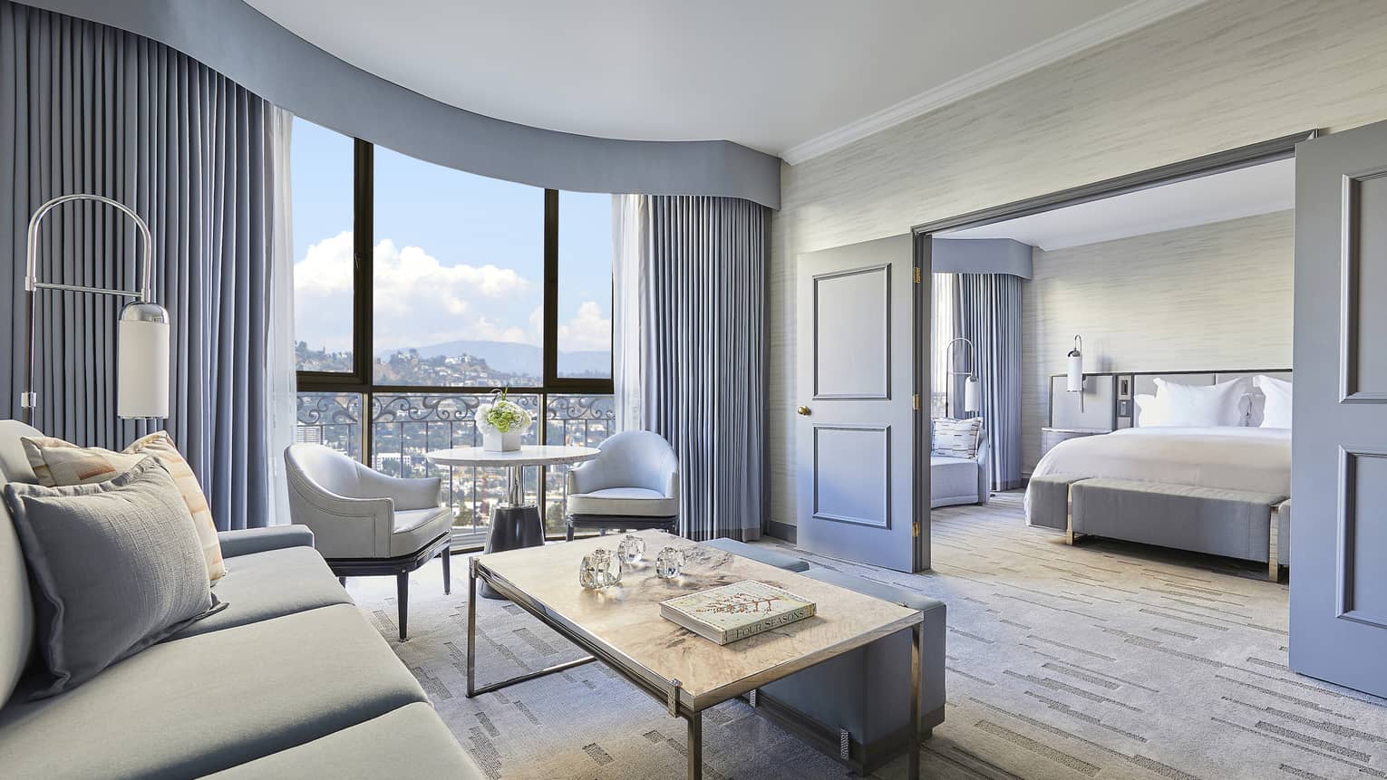 Hotel suite living room with sliding doors to bedroom