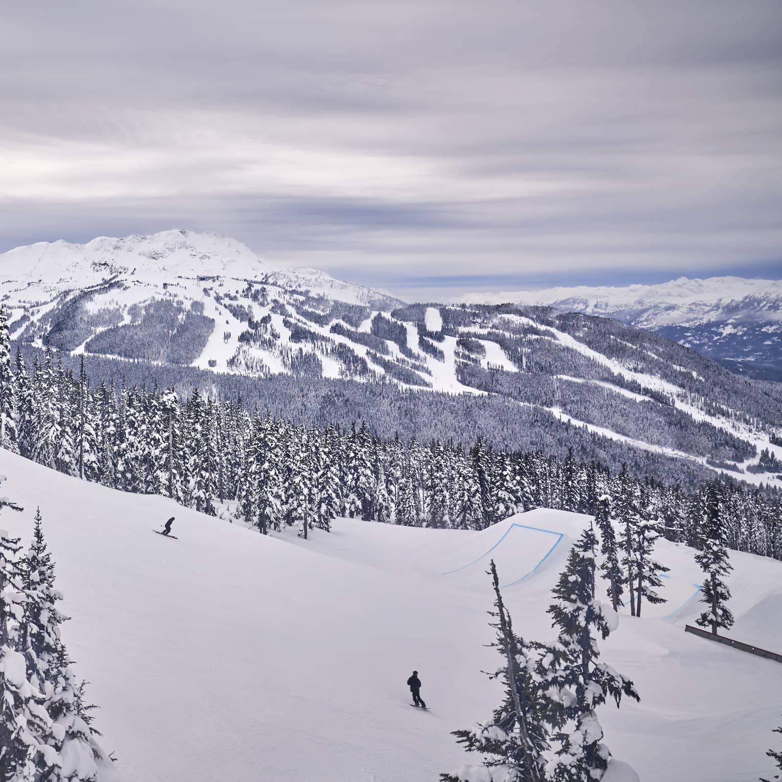A snow covered mountain with skiers.