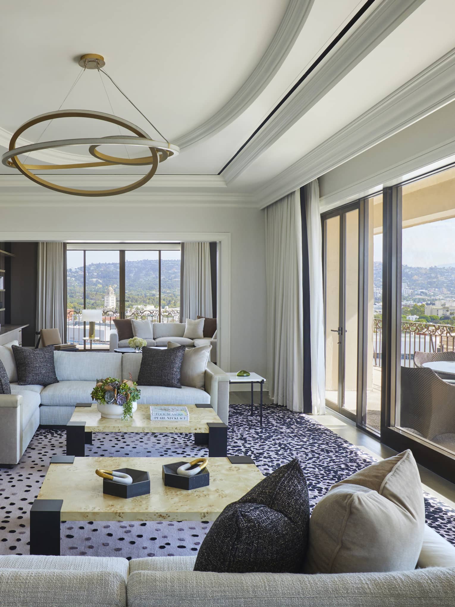 Large living room opening to city-view terrace