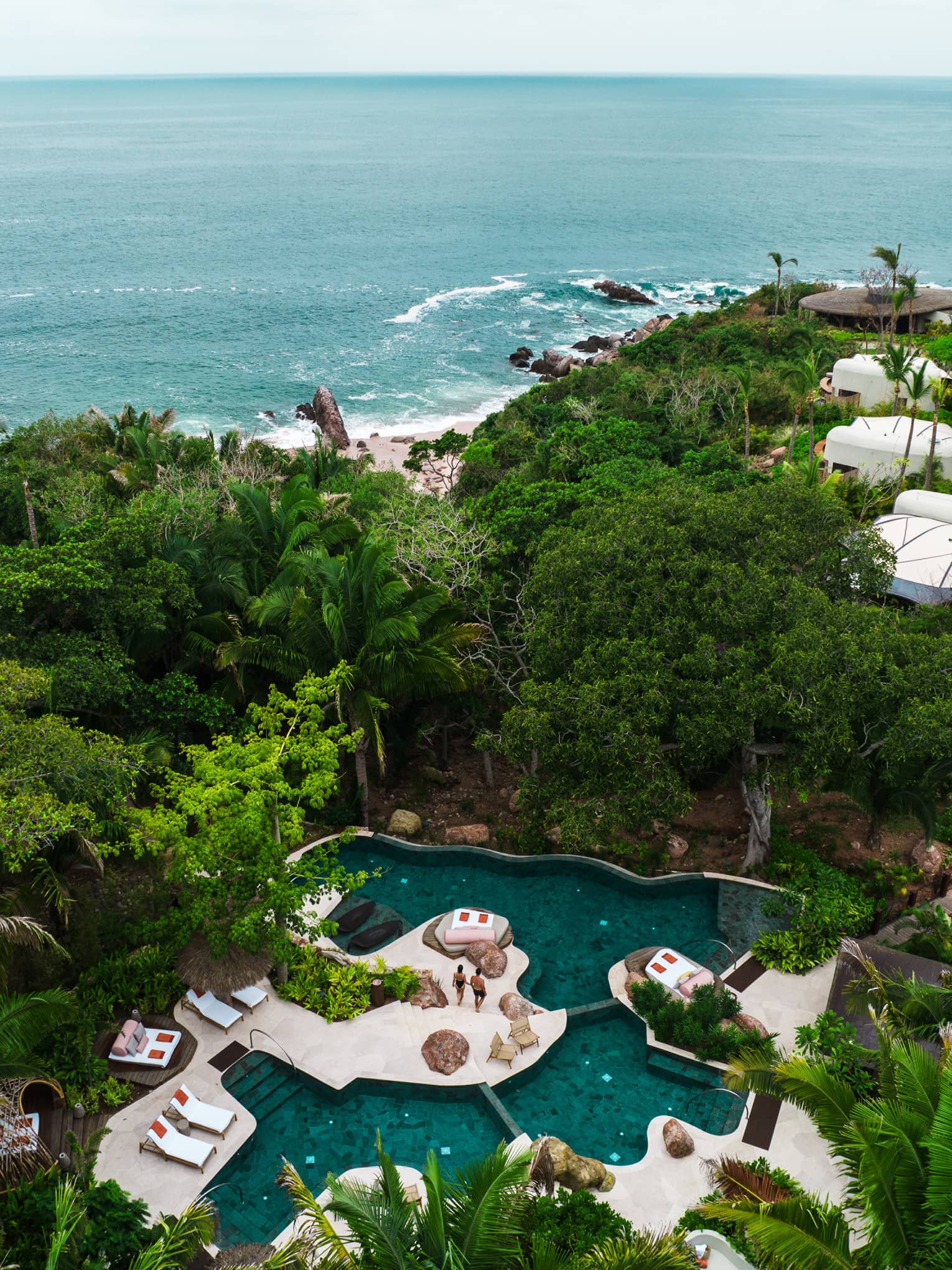 Luxury resort pool and ocean in the distance
