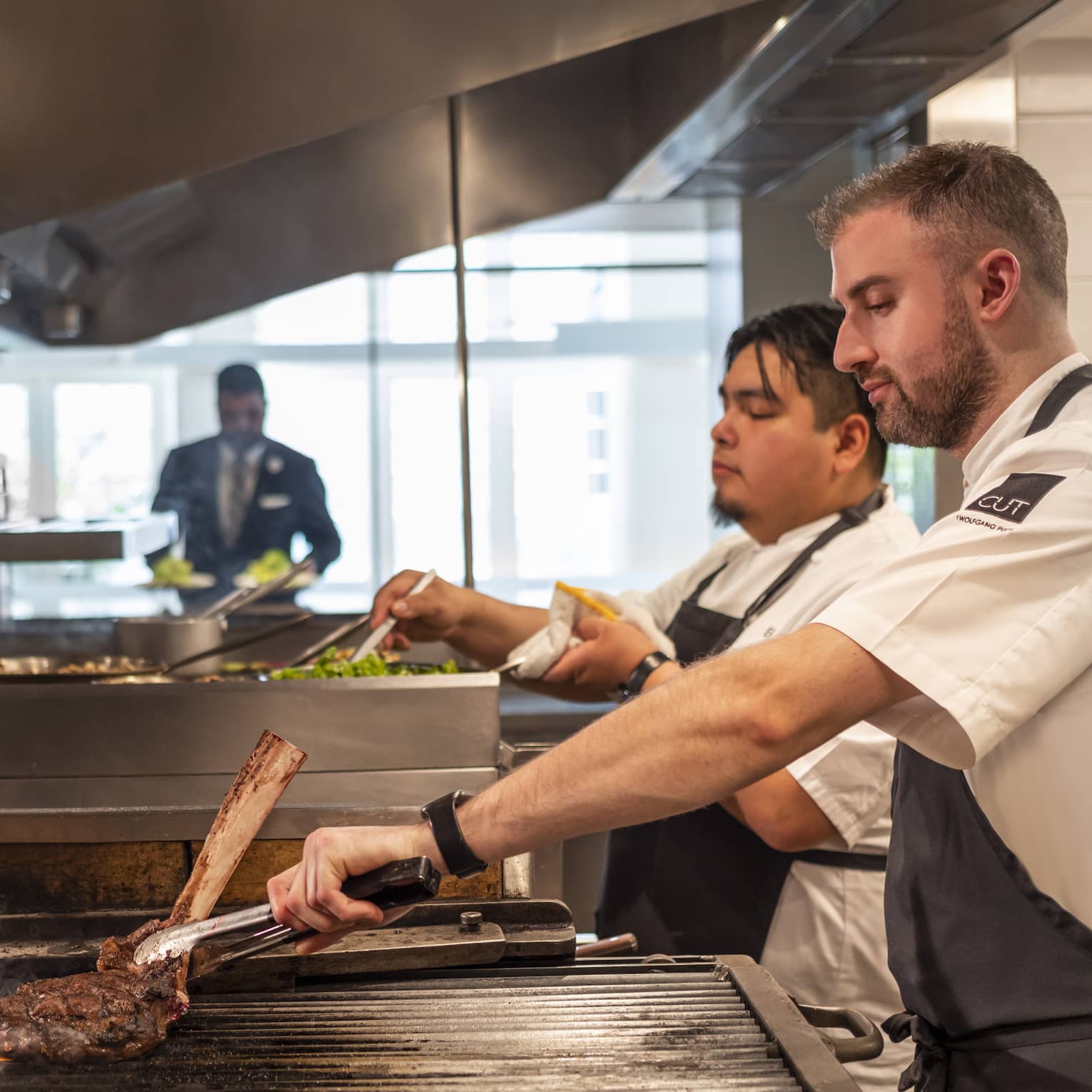 Chefs cooking food in a kitchen.