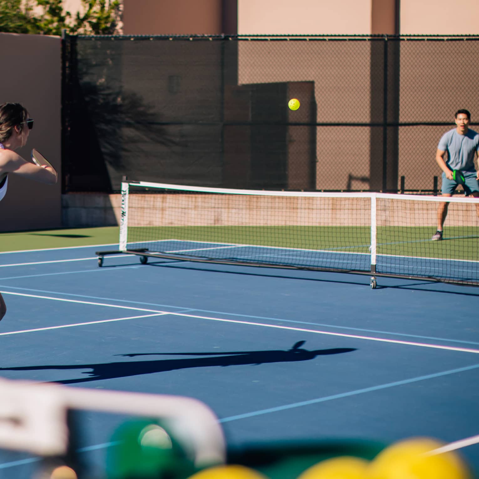 A woman and man on a tennis court.