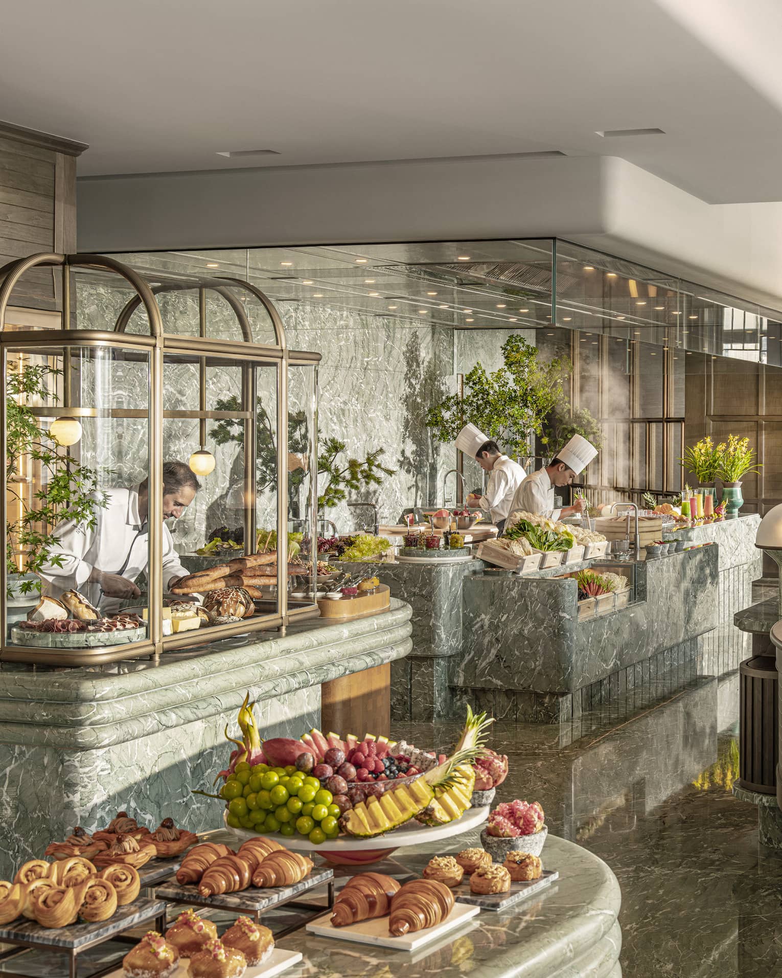 Chefs work at live-cooking stations at all-day restaurant Charm at Four Seasons Hotel Hangzhou at Hangzhou Centre