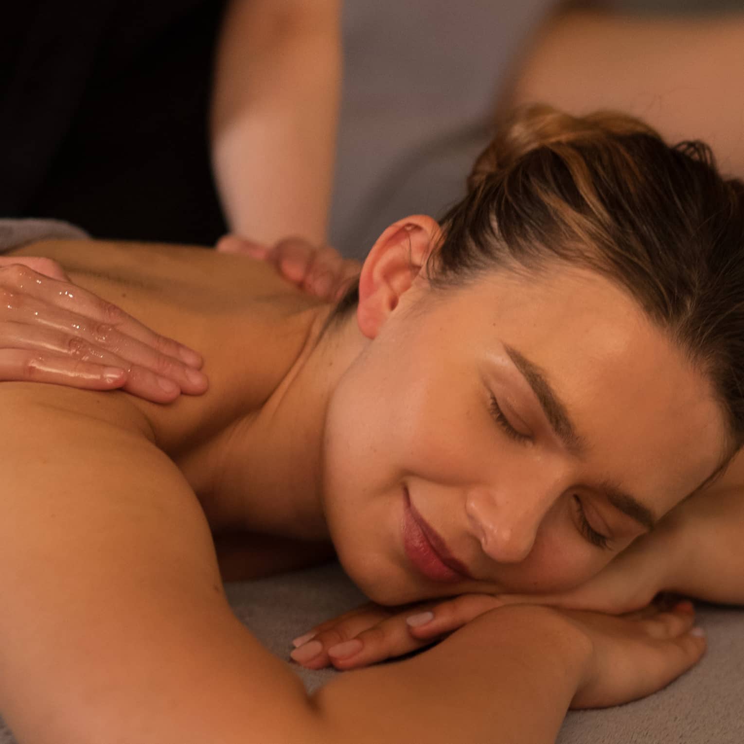 Two people laying on massage tables getting a massage.