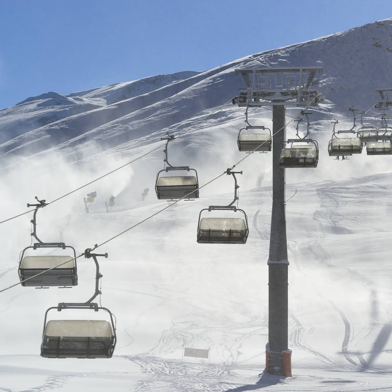 Chairlift cars passing over snowy mountain landscape at Shahdag Ski Resort in Azerbaijan