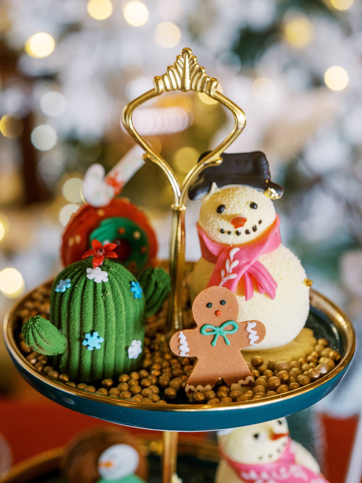 A display with a snowman and gingerbread man and lights in the background