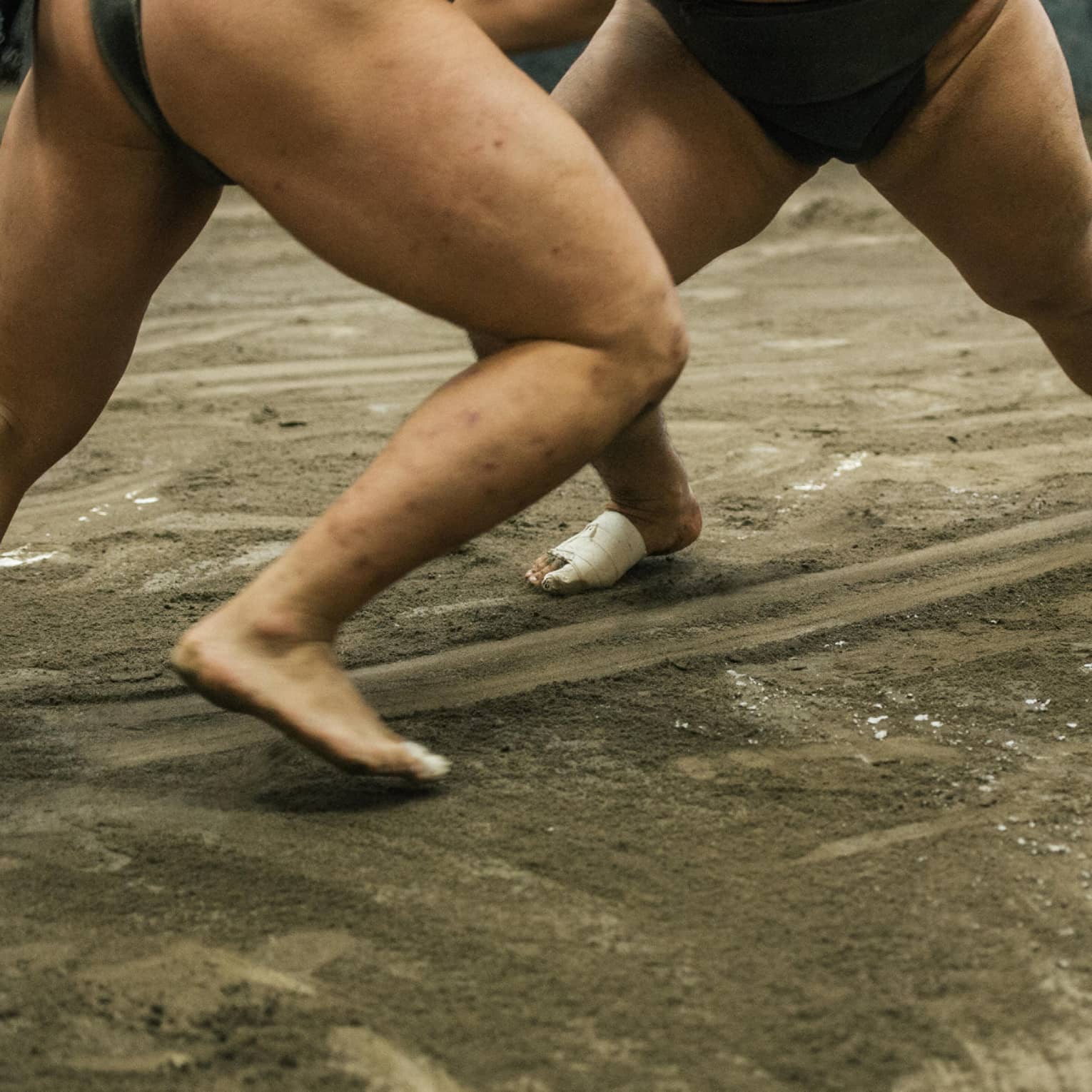 Two sumo wrestlers participate in a match