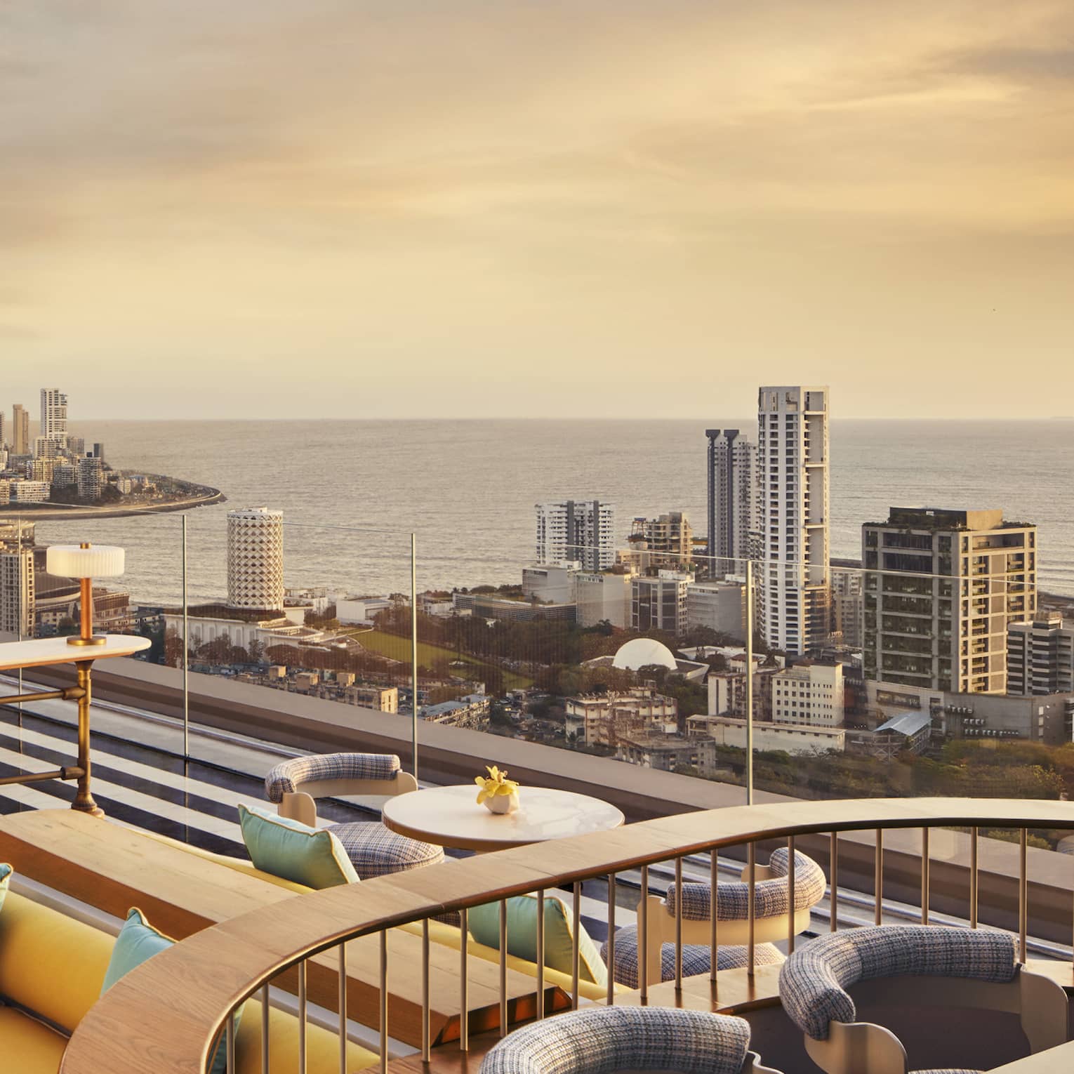 AER rooftop lounge at sunrise with views of Mumbai's skyline