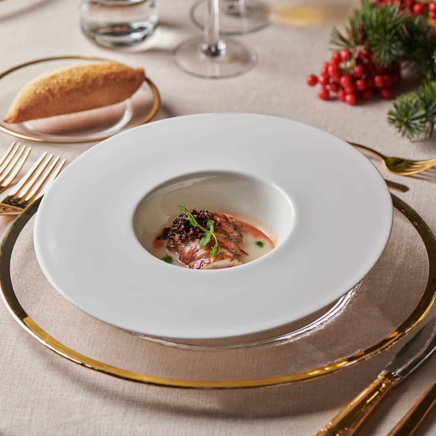 Elegant table setting with dish in round bowl in centre