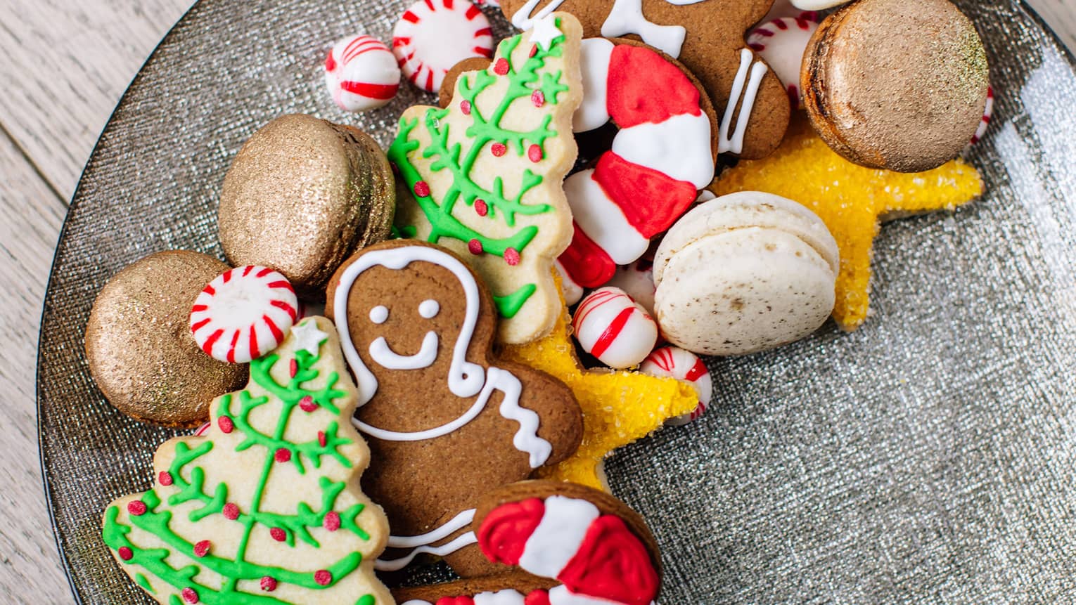 A plate of holiday sugar cookies – christmas trees and ginger bread men and candy canes