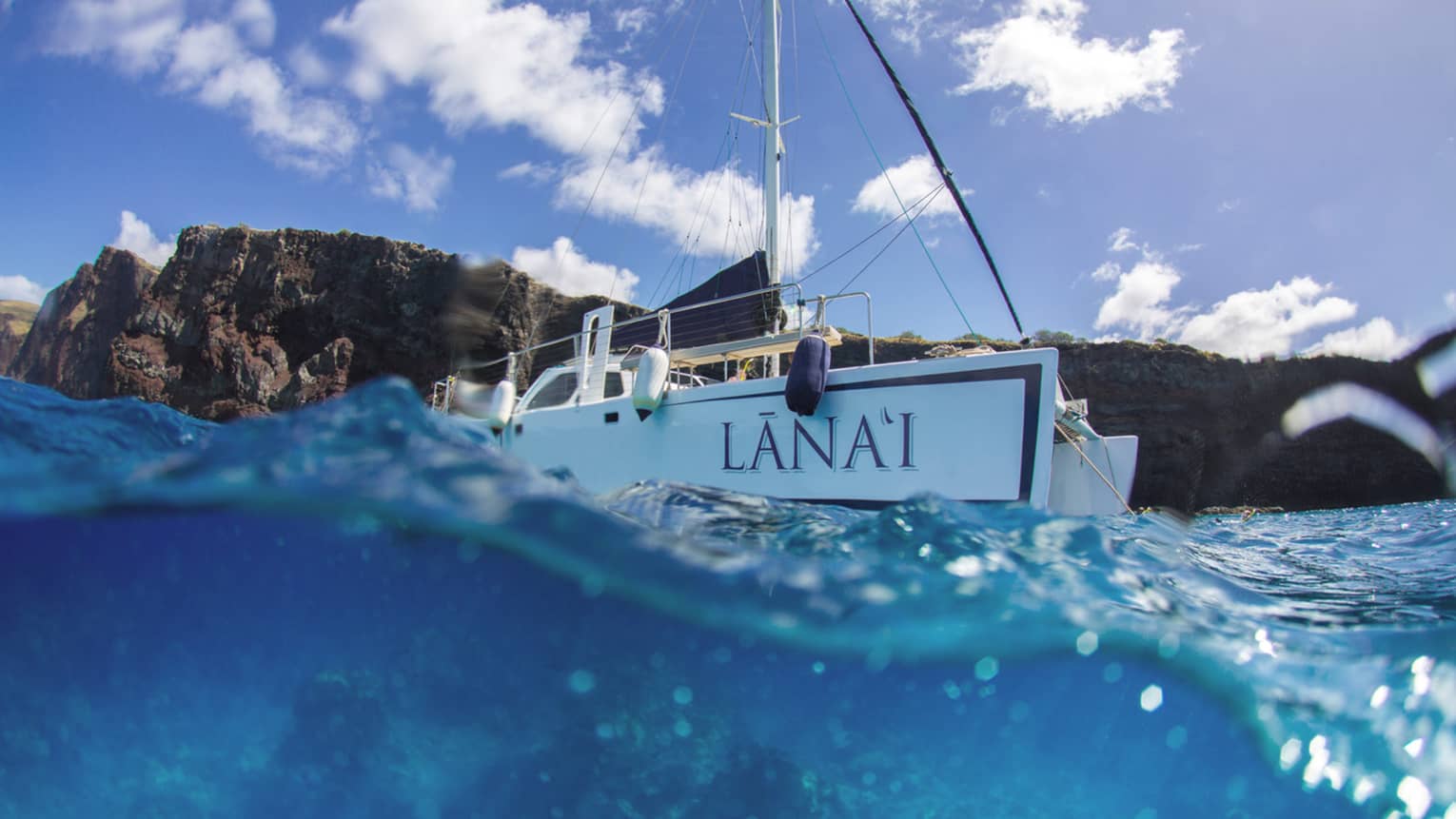 Lanai catamaran on blue waters headed out to sea