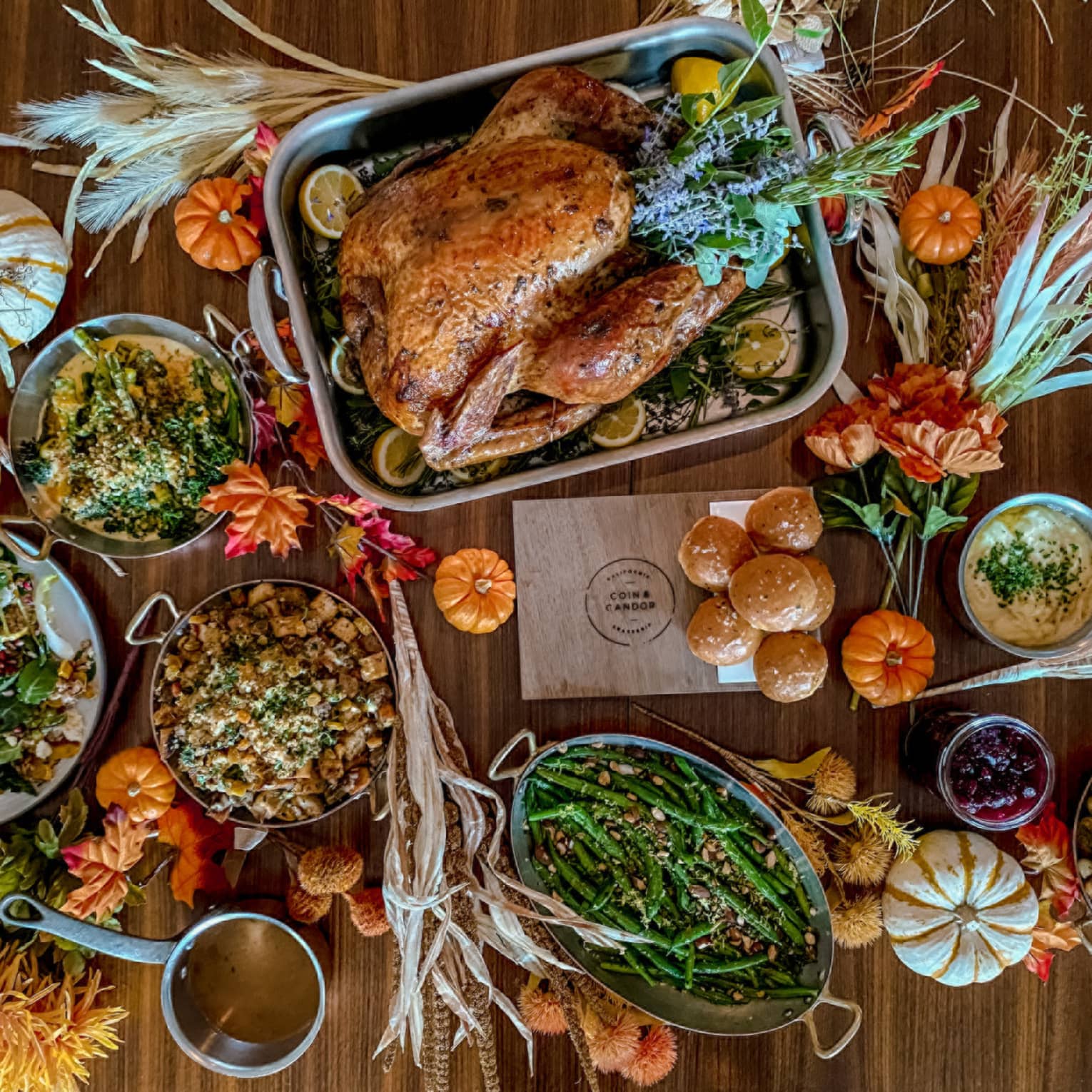 An assortment of thanksgiving food, including turkey, green beans, potato, and various other vegetables.