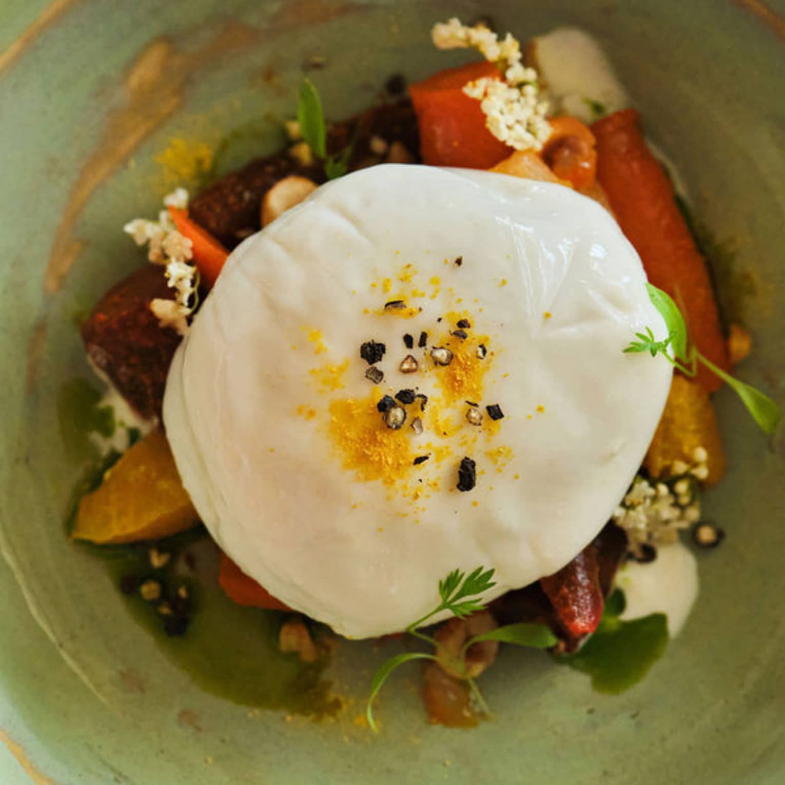 Burrata paired with seasonal produce, bright citrus and delicate herbs