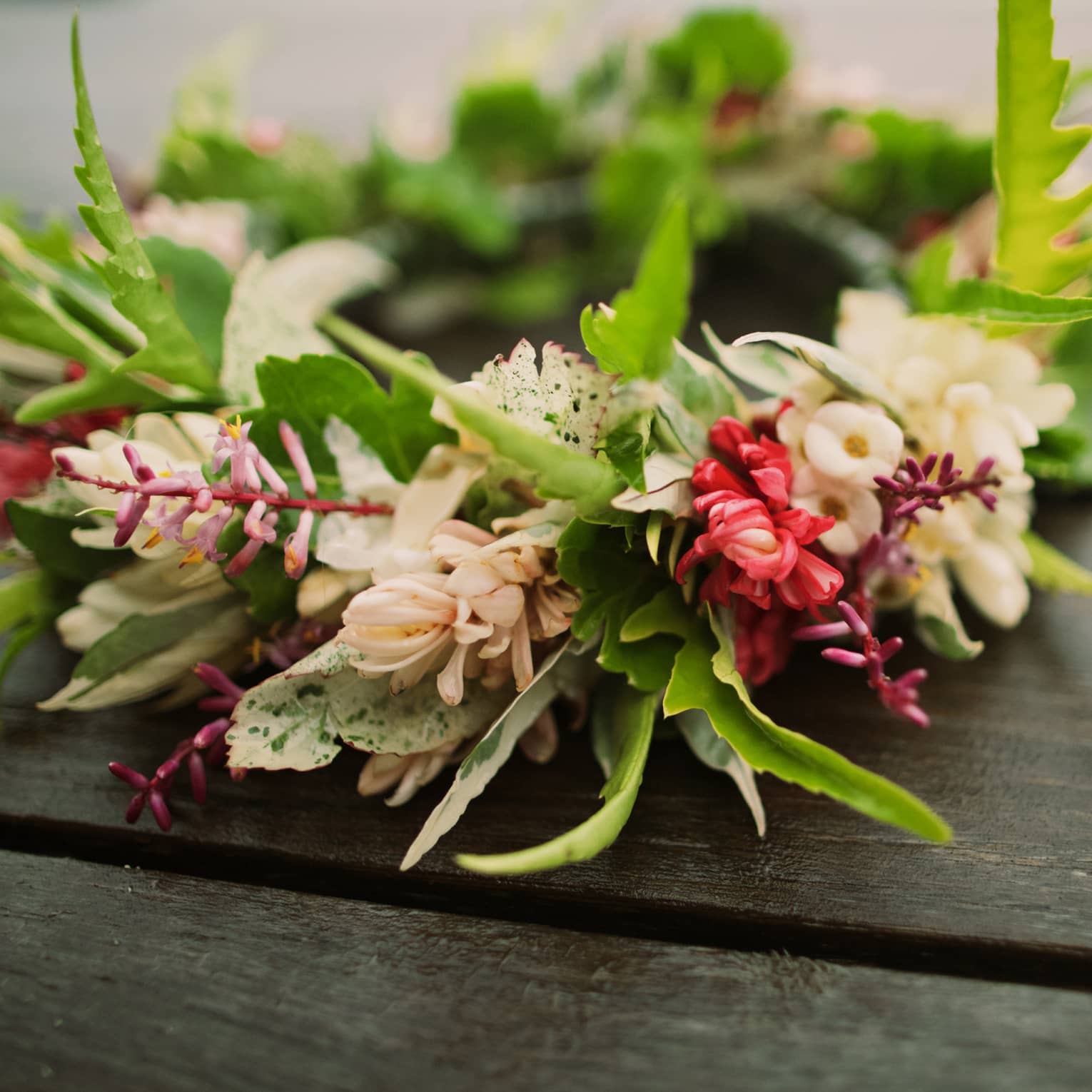 Tropical flowers arranged in floral wedding crown on table