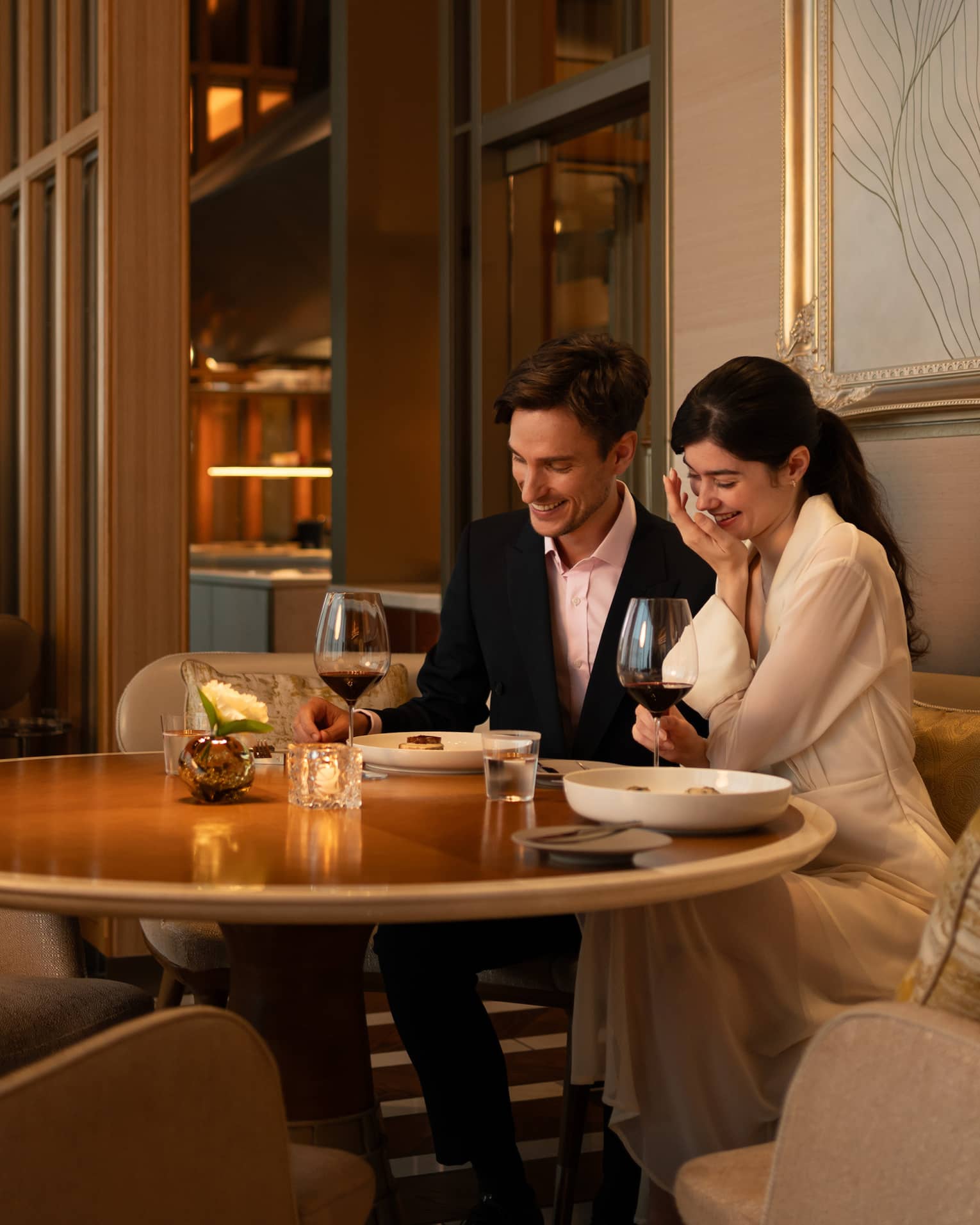 A couple enjoys a romantic dinner at est, a French restaurant in Tokyo, savoring fine wine and cuisine.