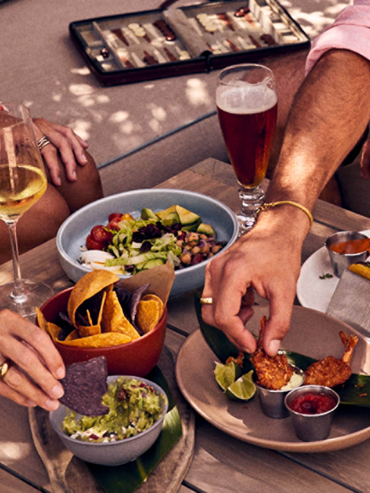 Guests enjoy a spread of food and drinks outdoors