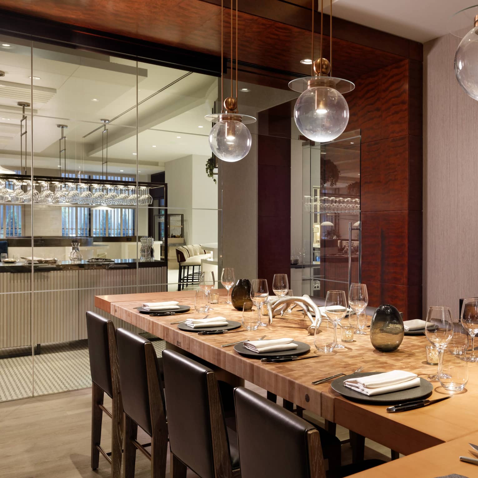 A large dining table with a carving station next to a clean open kitchen.