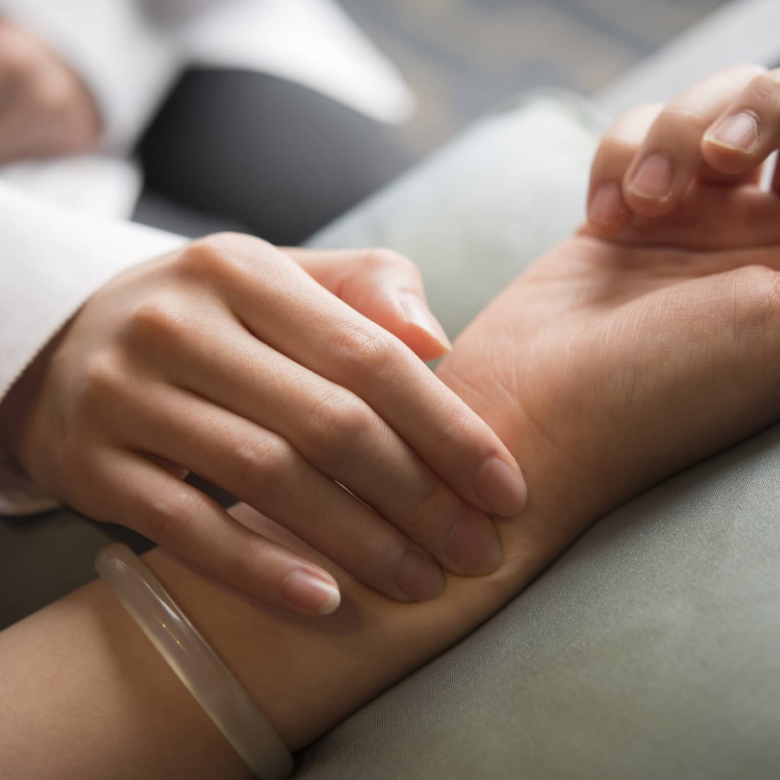 Hand placed on wrist in spa