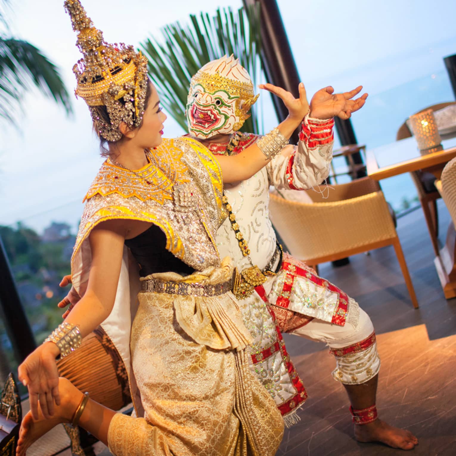 Two dancers in colourful traditional outfits perform outdoors, embodying cultural heritage and festive spirit.