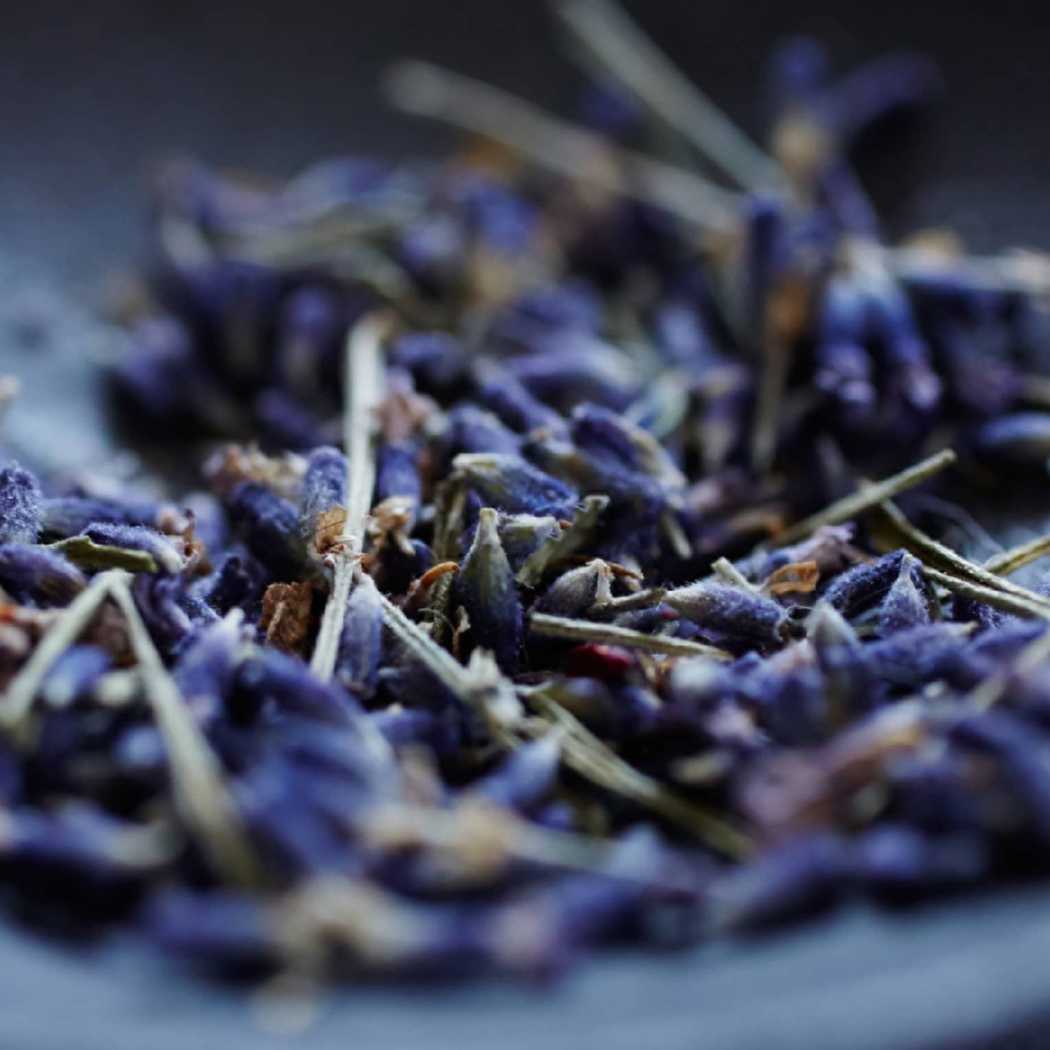 Lavender flowers in a grey bowl.