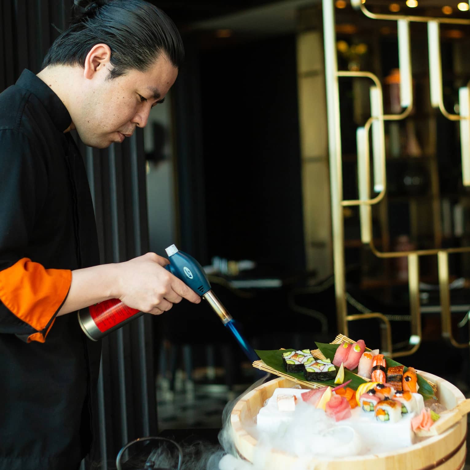 Chef Yonaha uses a torch to put the finishing touches on a signature dish