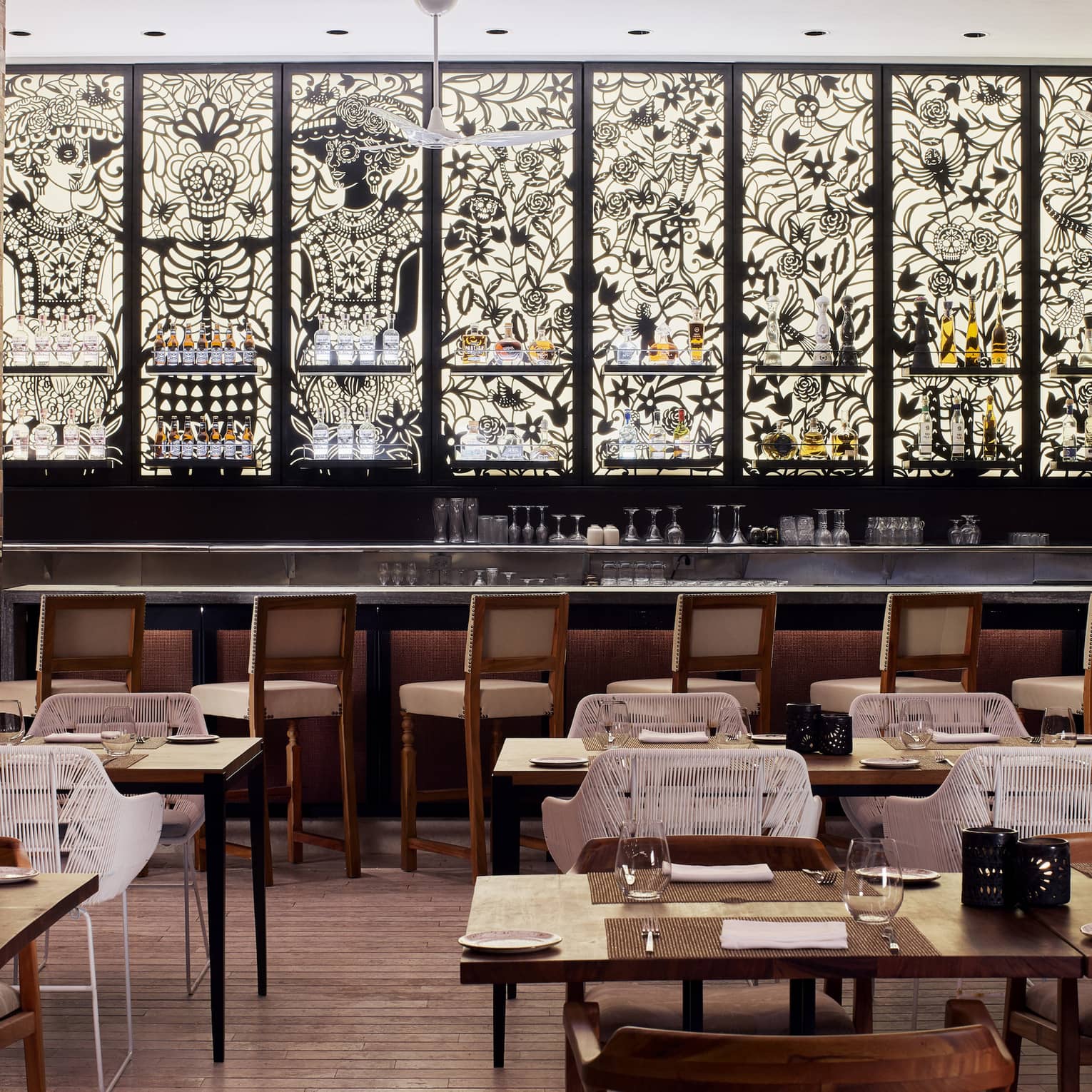 Black and white mosaic stain glass windows line the interior walls of Dos Catrinas