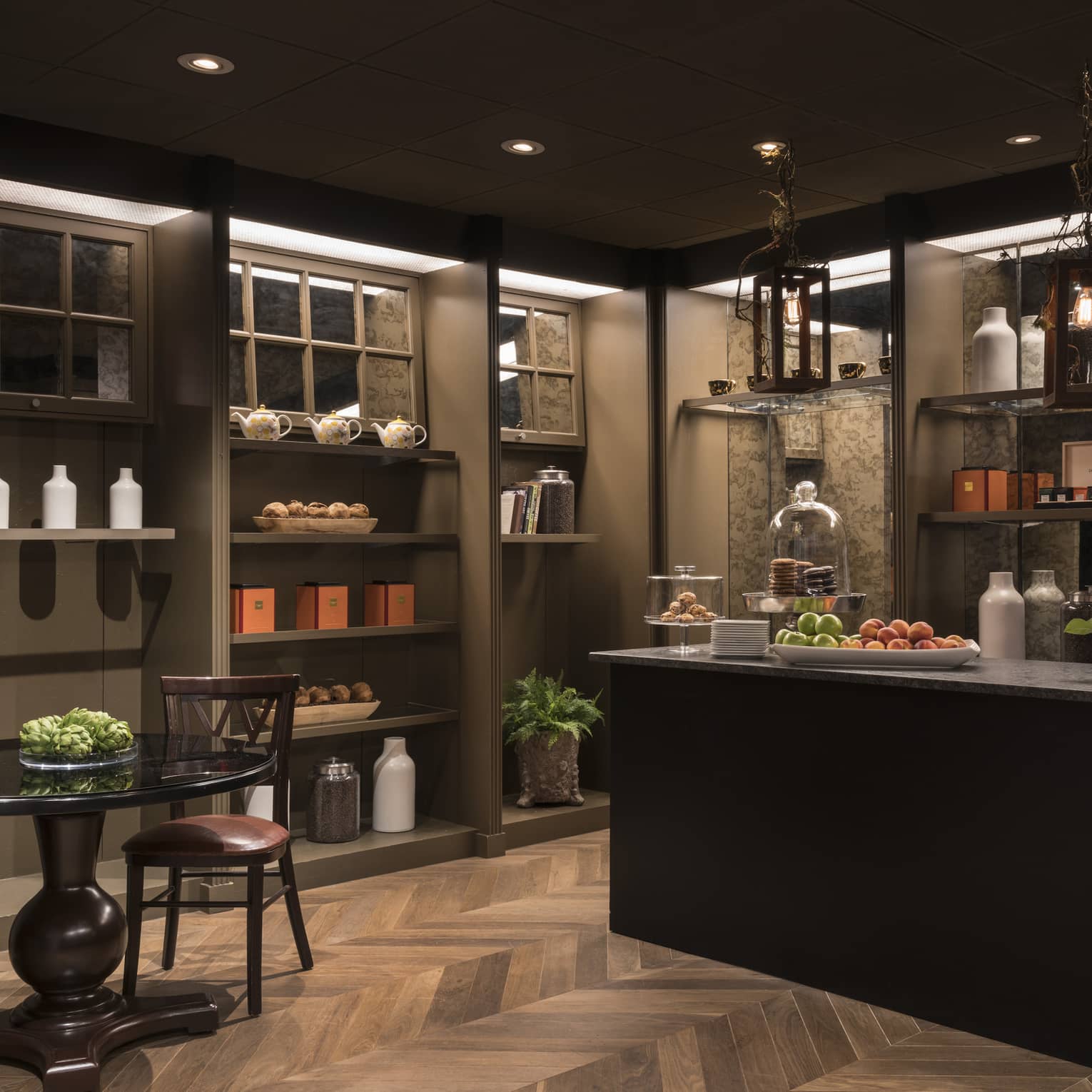 A coffee store that dimly lit with a counter and small table.