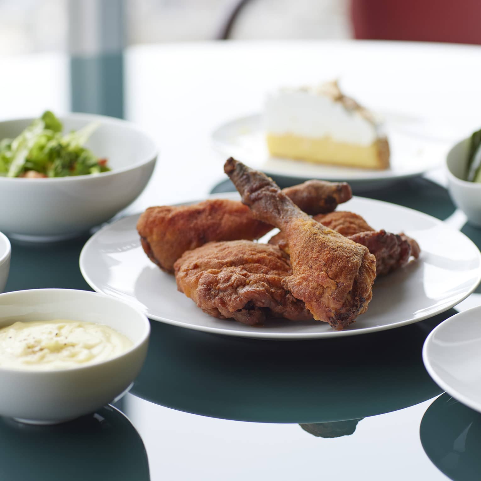 Marunouchi Fried Chicken with Cobb Salad & Kale Dressing, Braised Kale, Mashed Potatoes, Cornbread, House-made Pickles, Ranch Dressing and Lemon Meringue Pie