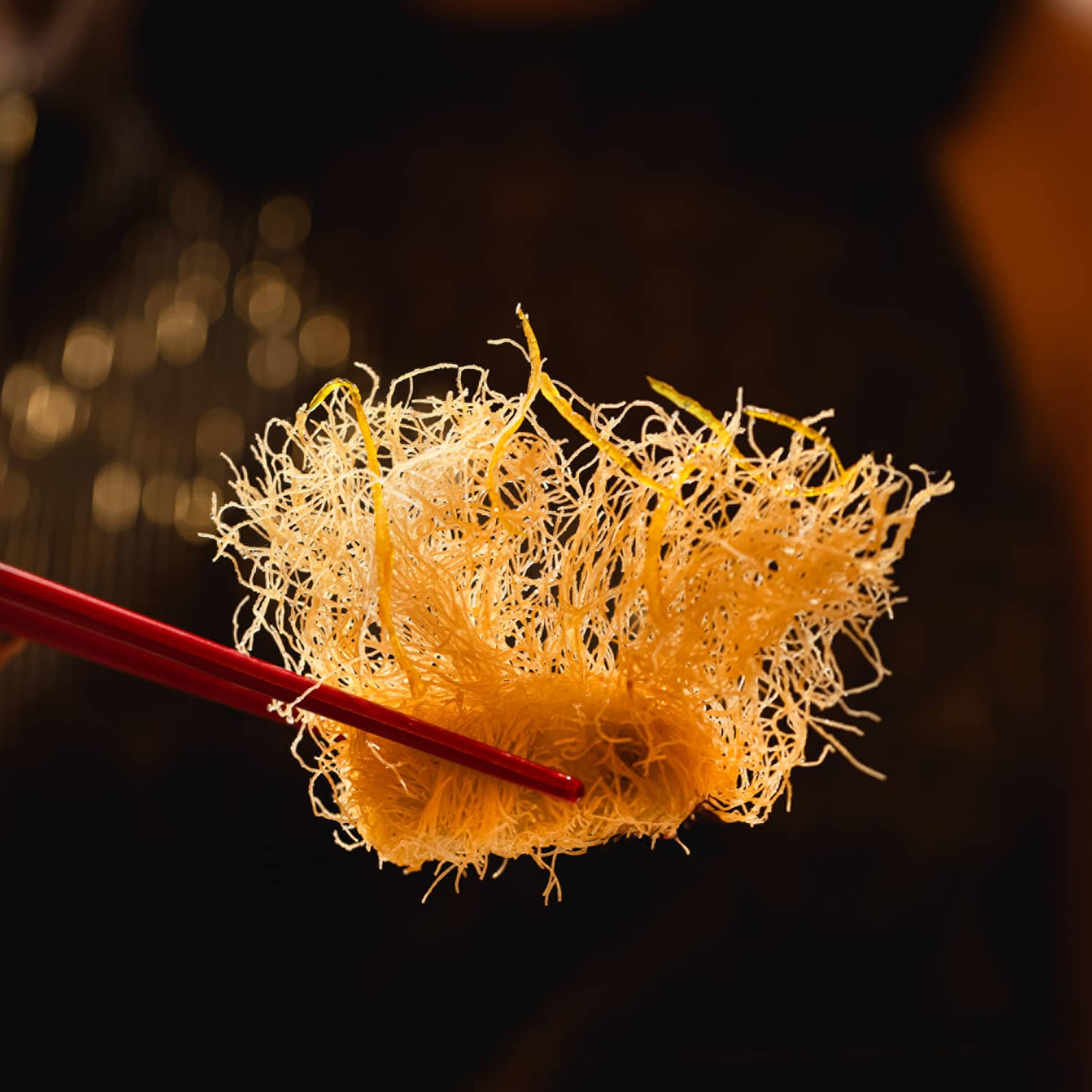 Chopsticks holding food.