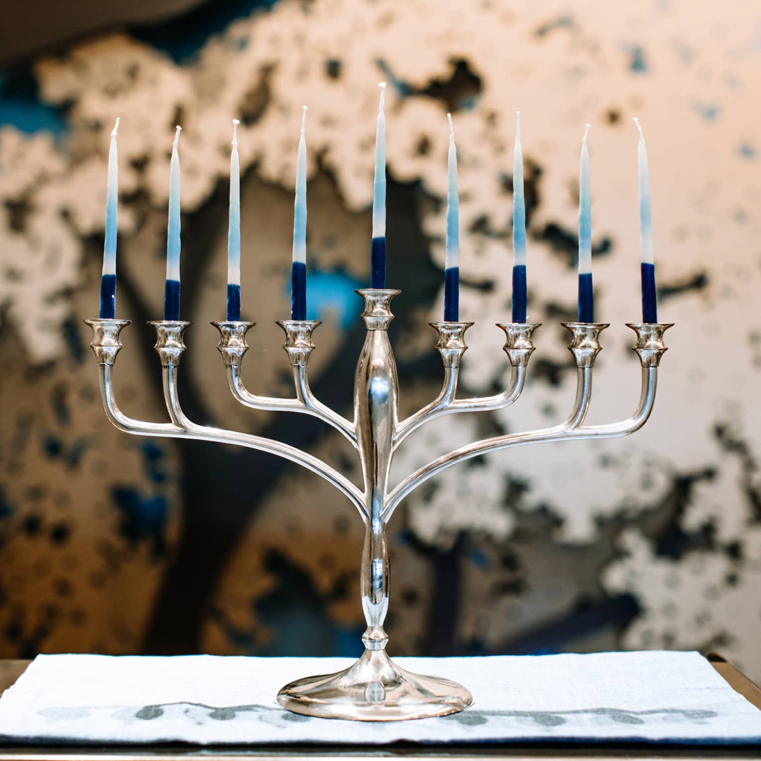 A silver menorah with 9 candles.
