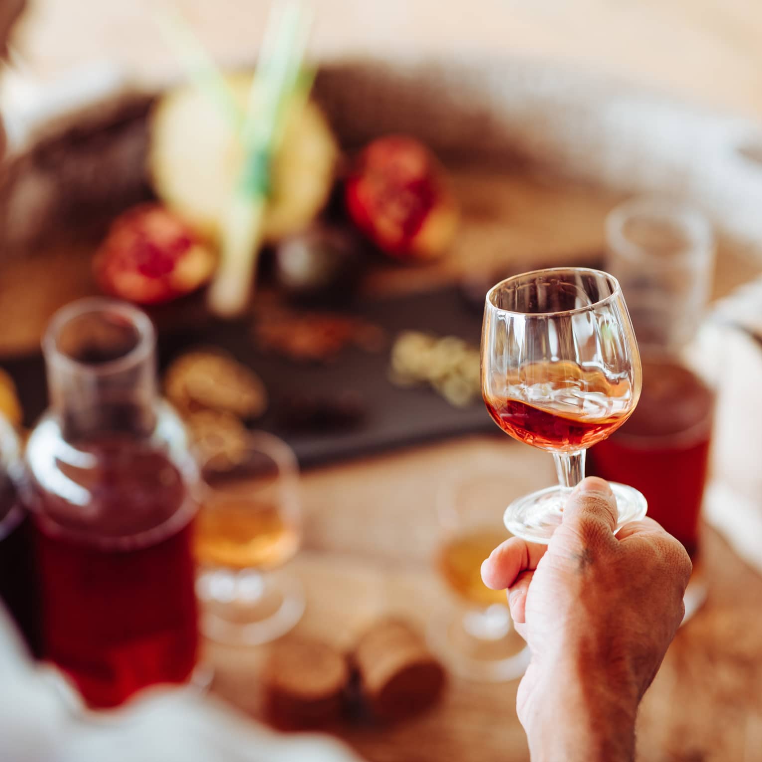 A person holding a clear glass of rum