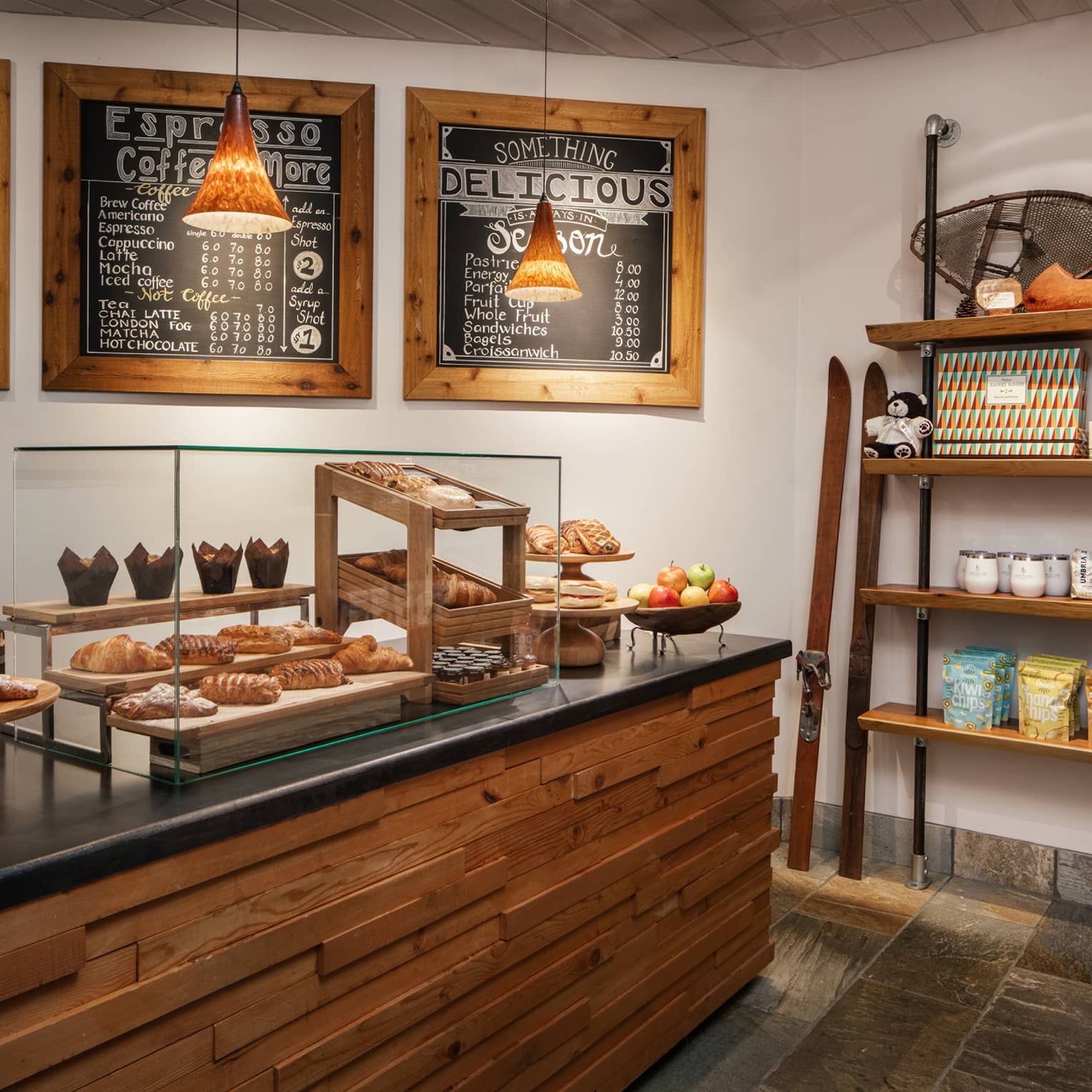 A cafe with pastries on display and coffee for sale.