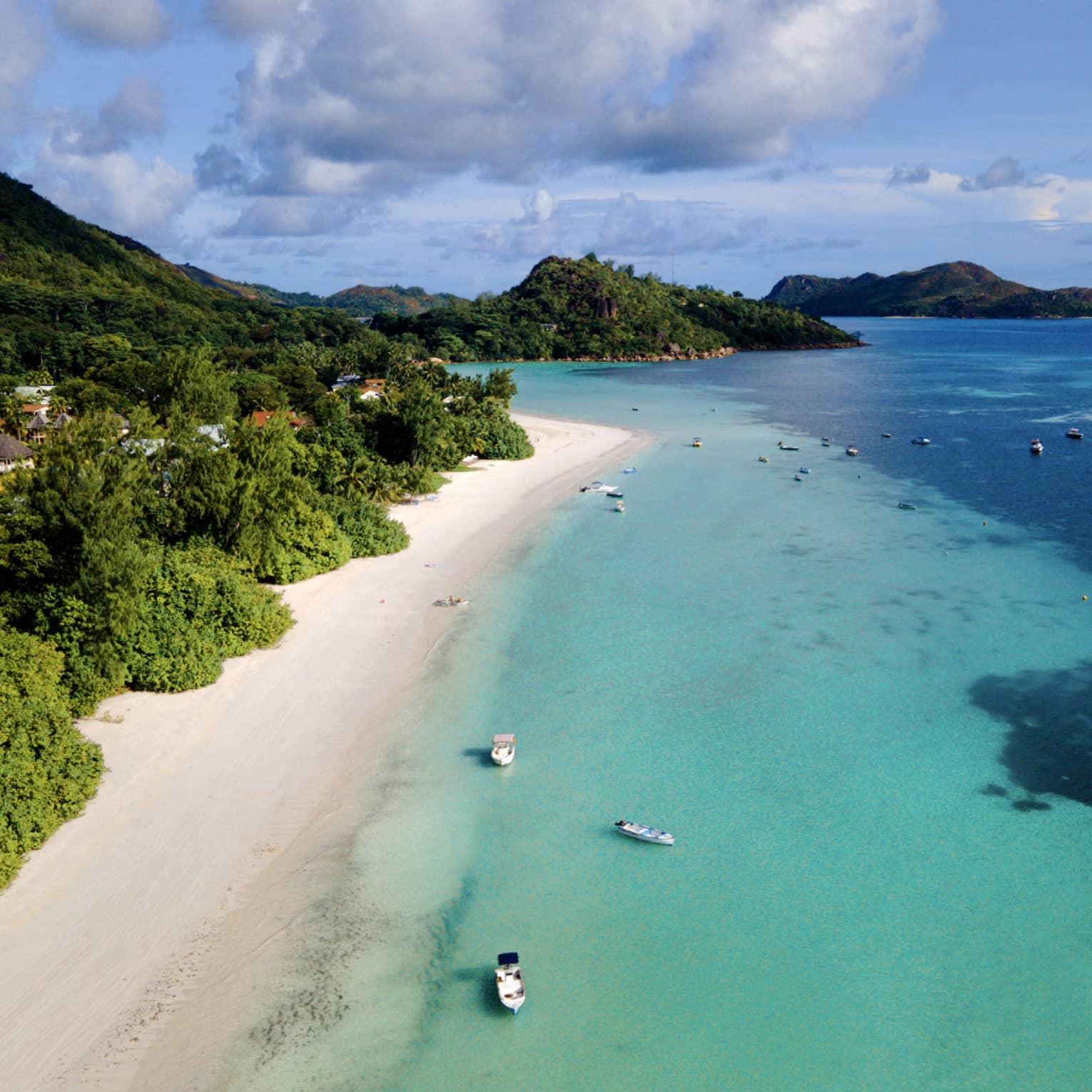 Stretch of white-sand island beach with turquoise water